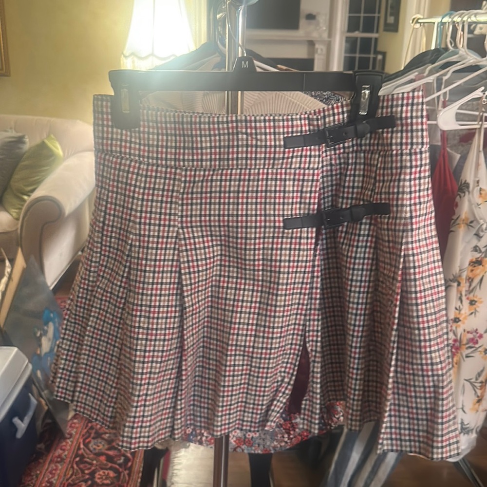 Pleated plaid skirt with black straps bought in local boutique in Ireland